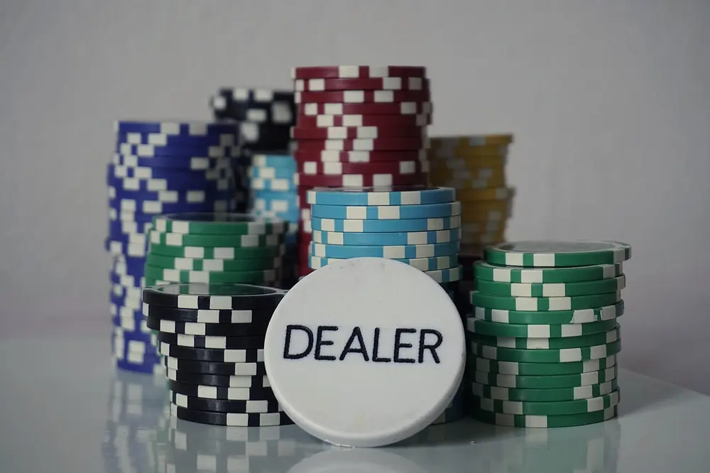 thrill casino no kyc - poker chips and a dealer button